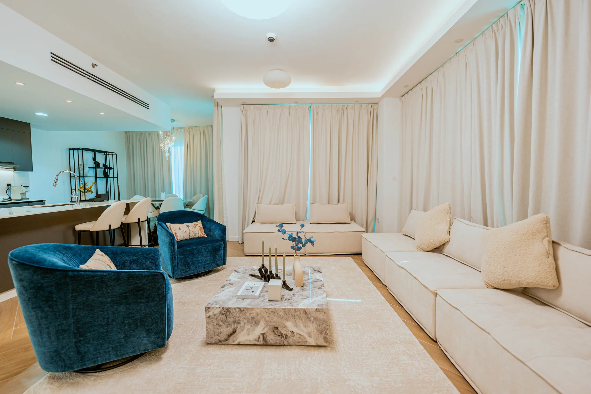 Delphine apartment living room with velvet seating and a stone coffee table