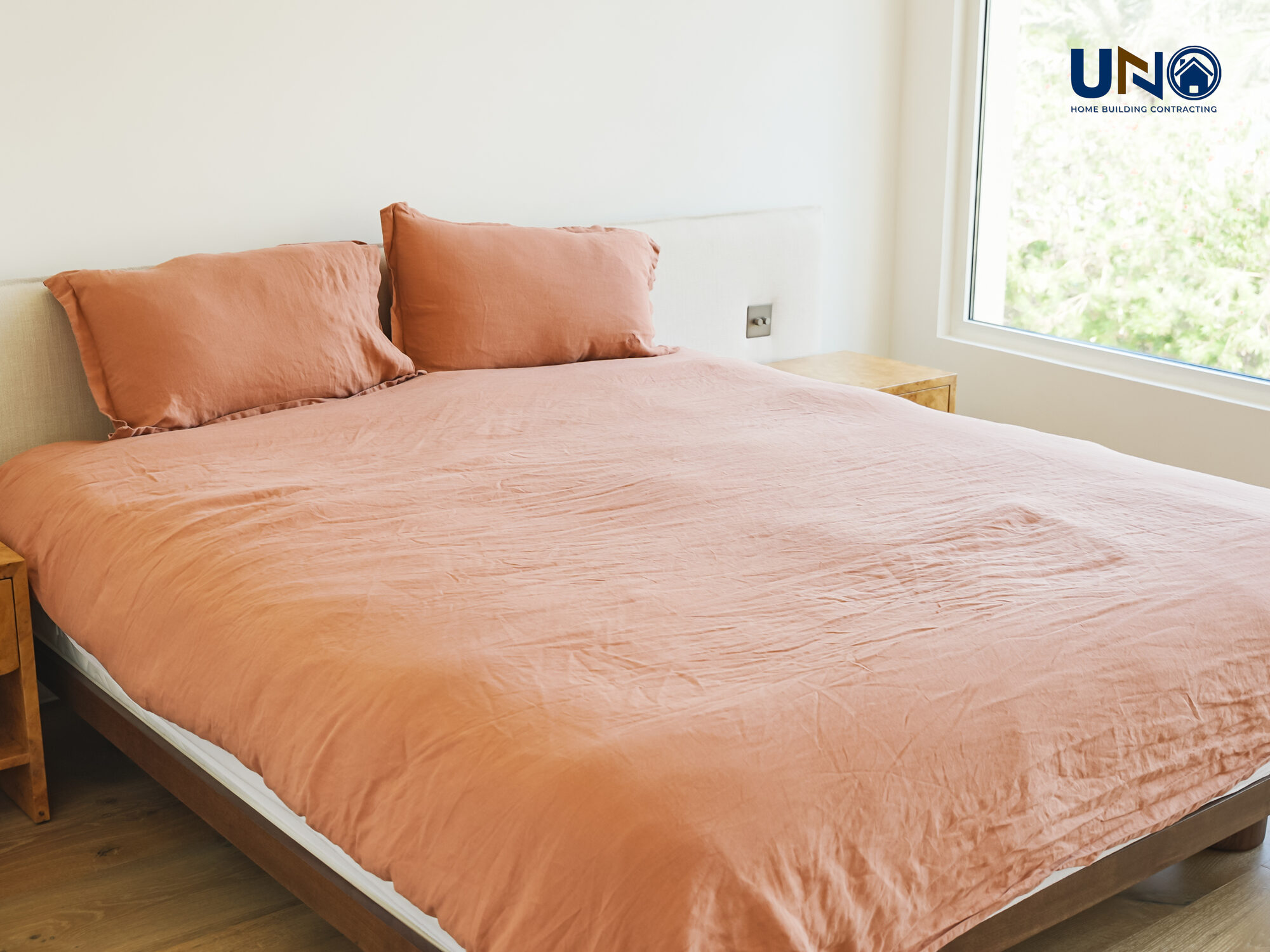Bedroom with layered bedding in warm terracotta tones