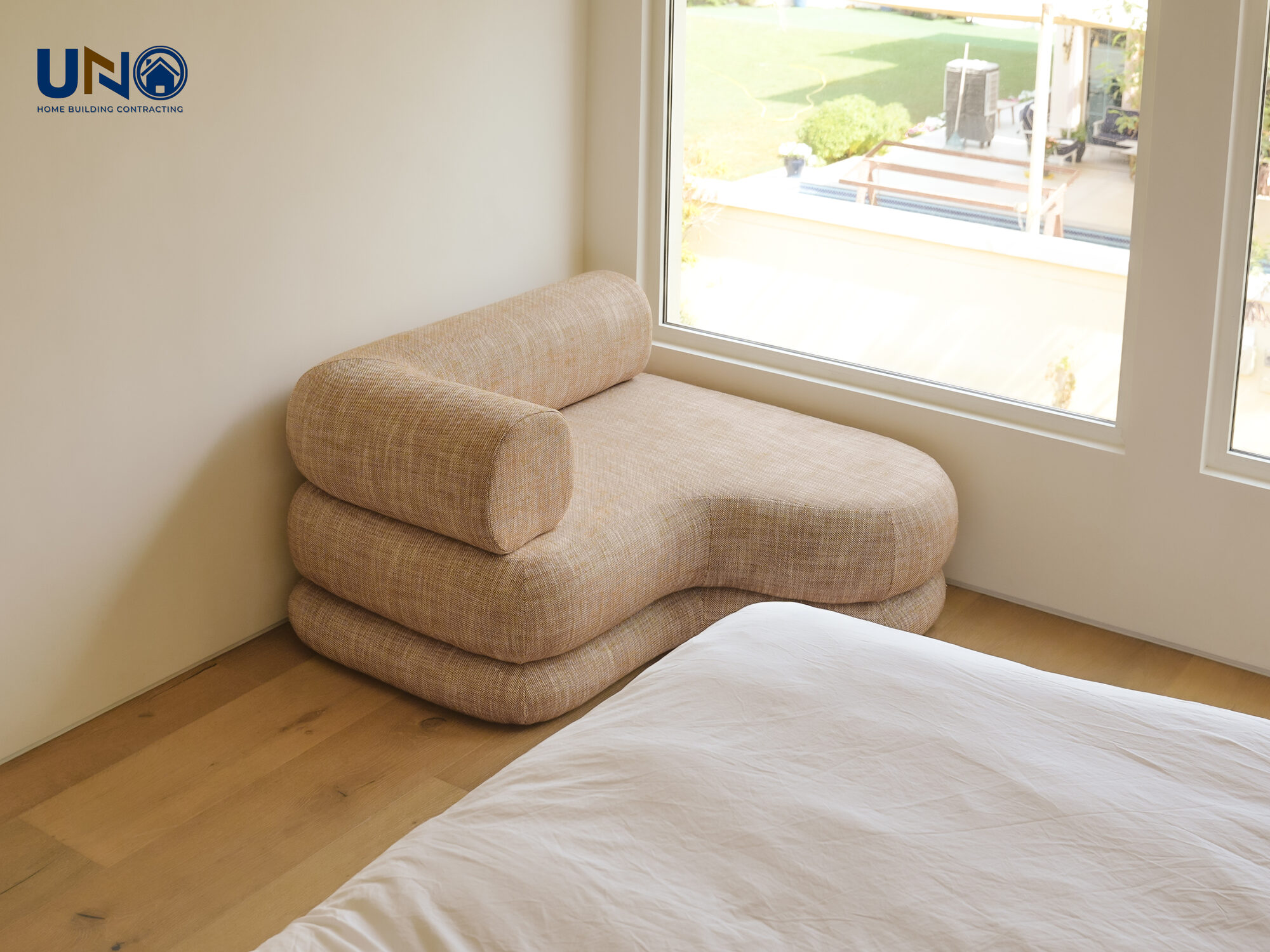 Bedroom with a window seat and built-in joinery