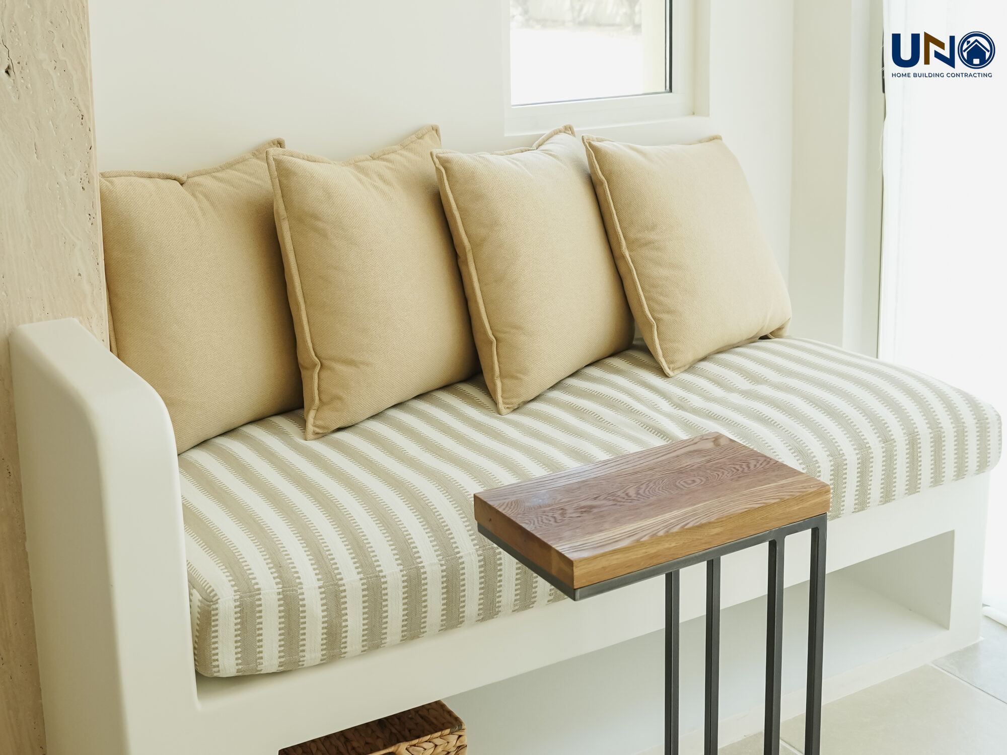 Majlis seating with a striped bench and a warm neutral palette