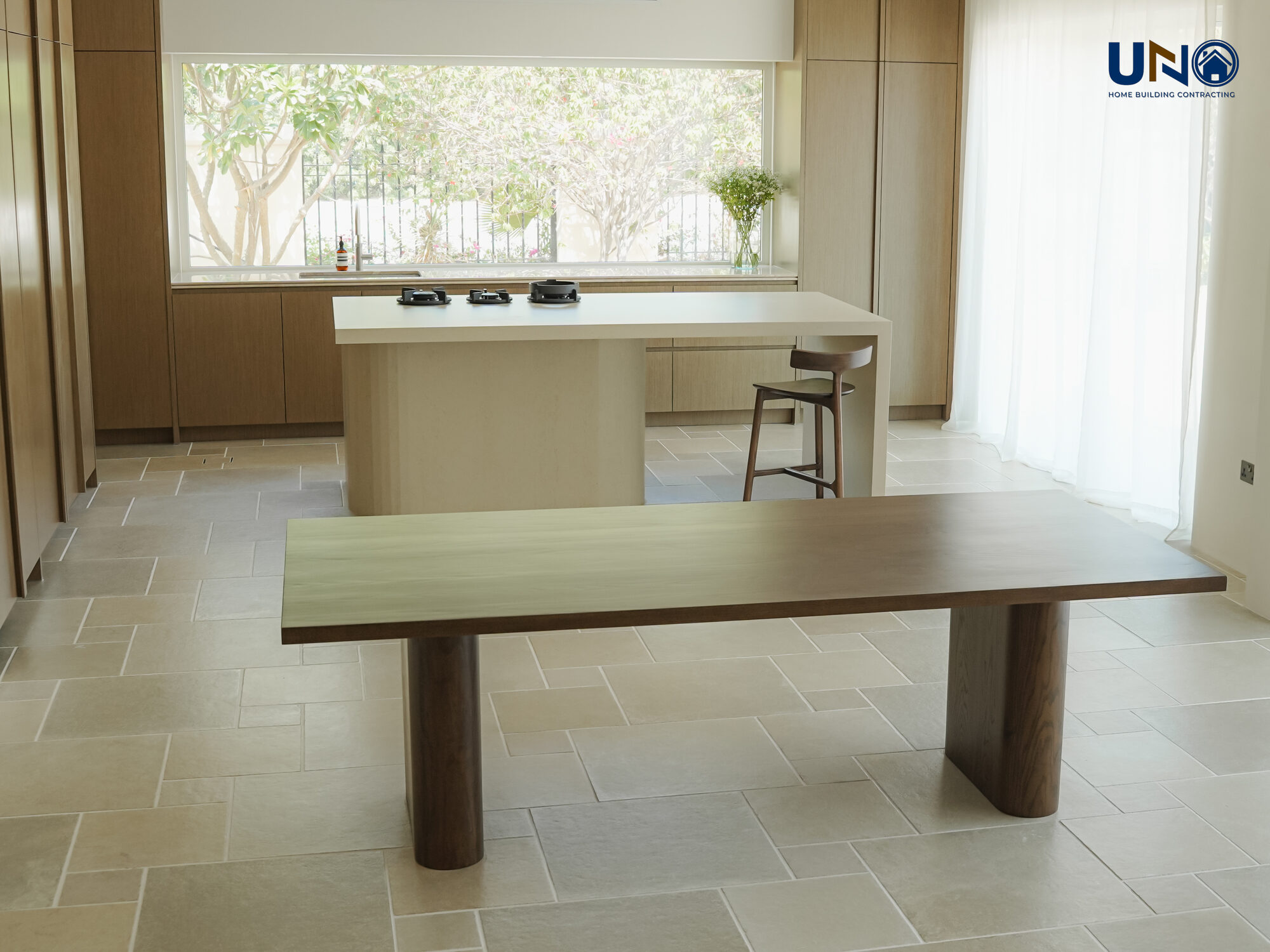 Dining area with bespoke joinery and a stone-topped table