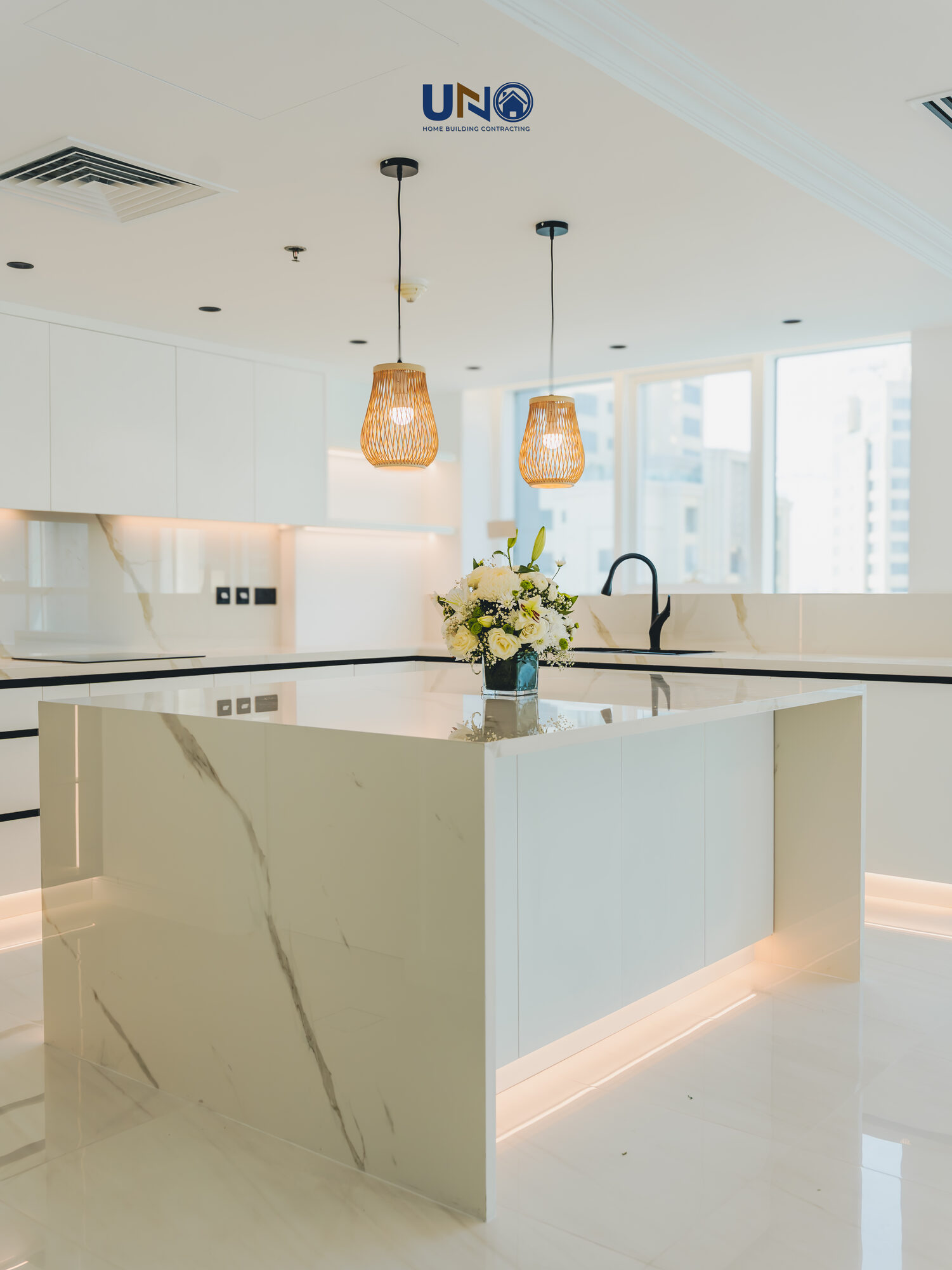Renovated kitchen with pendant lighting and a bright island