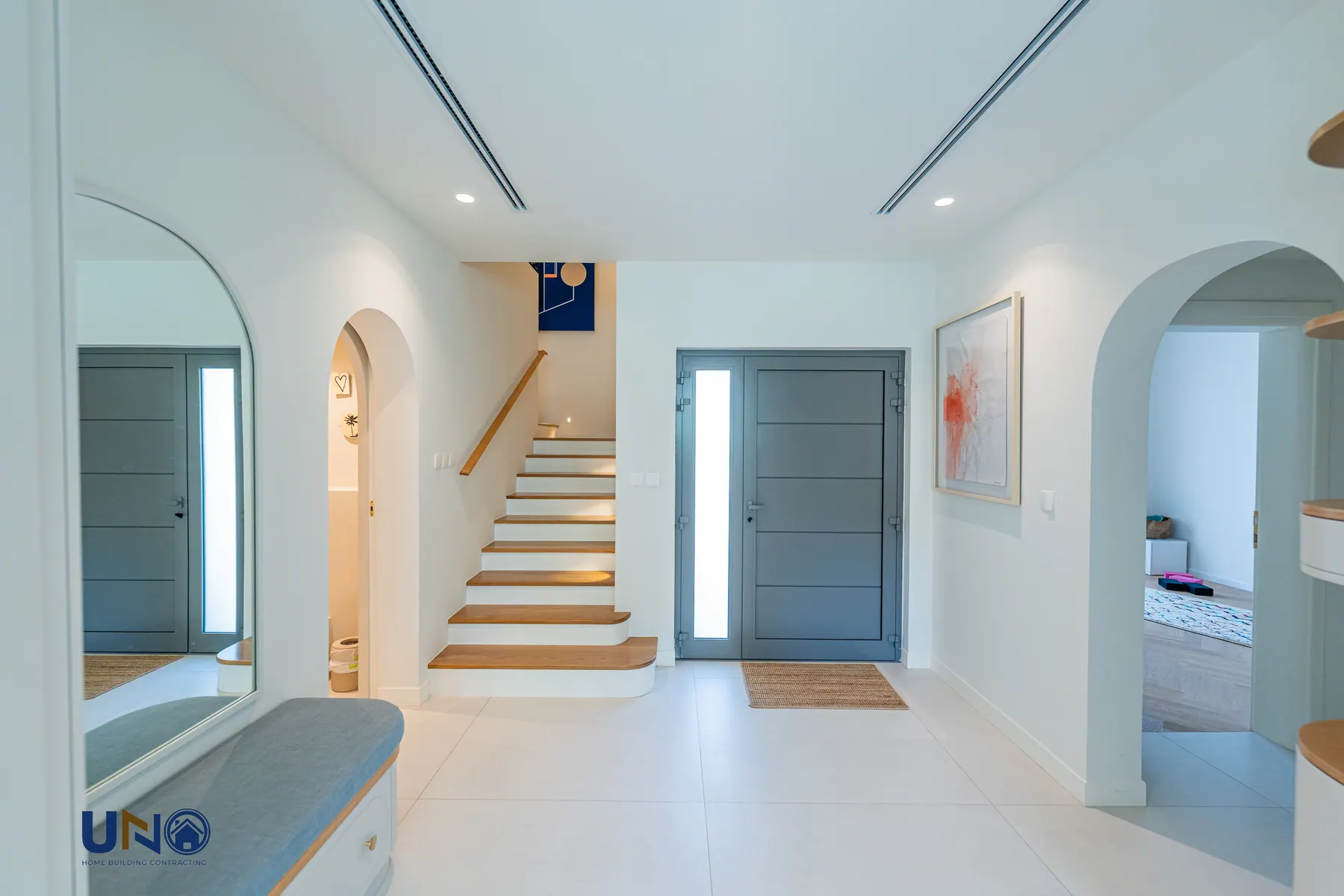 Entrance hall and staircase after renovation in a pale, open finish
