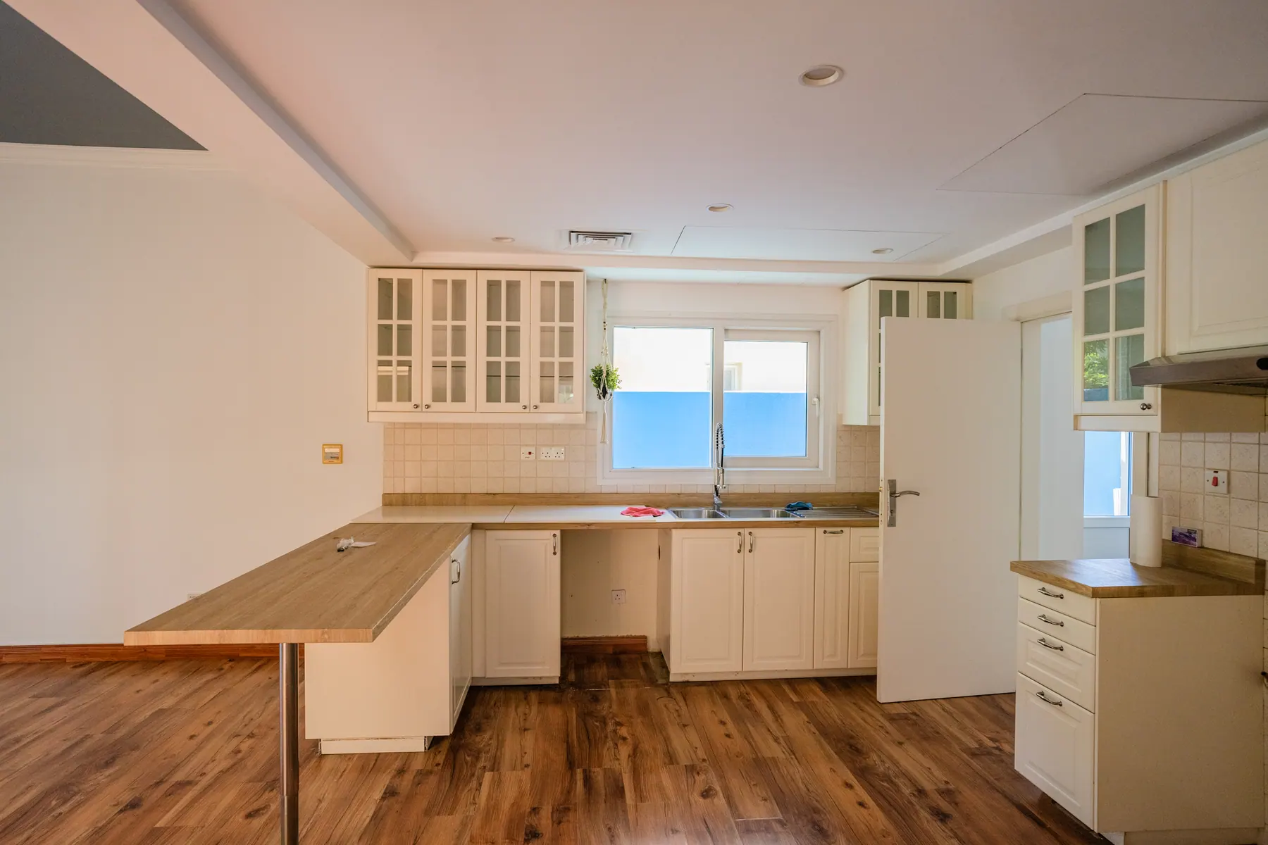 Original kitchen before renovation with dated white units