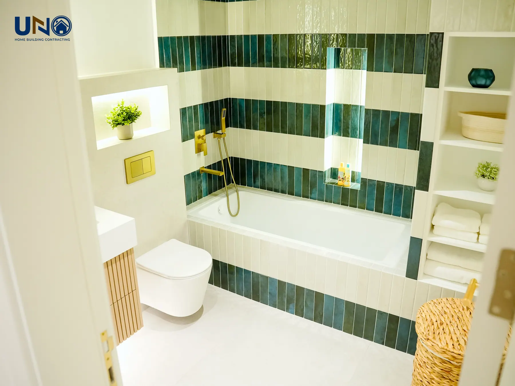 Family bathroom with green glazed tile and brass fittings