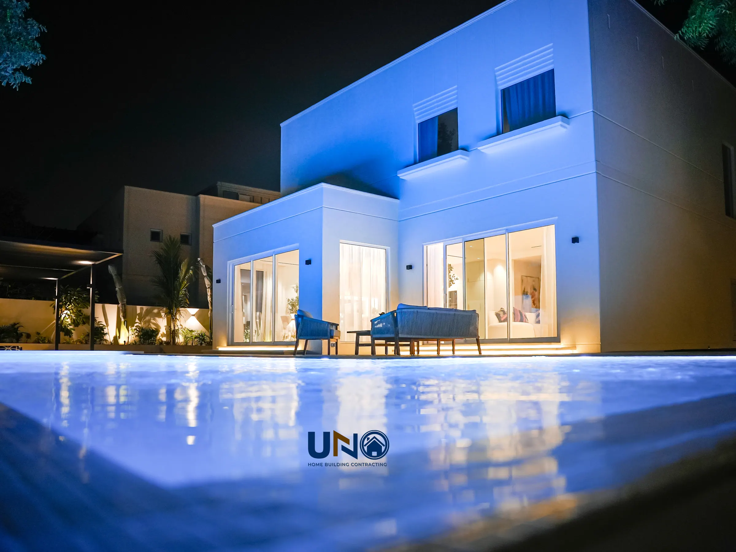 The Meadows villa exterior lit at night with the new pool