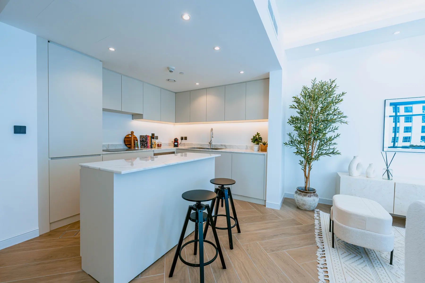 Open-plan kitchen with a stone island and bar seating