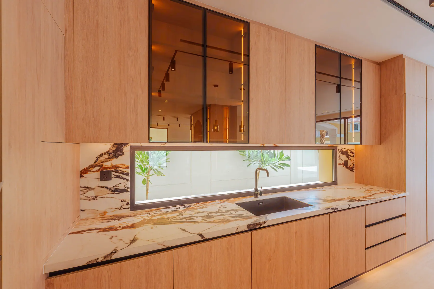 Kitchen detail with a viola marble splashback and integrated window