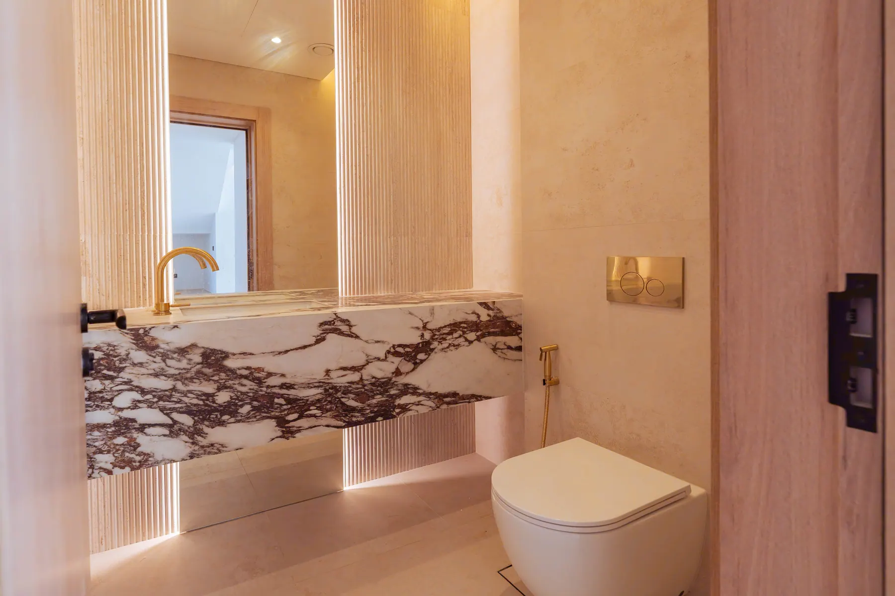 Guest bathroom with a viola marble vanity and travertine walls